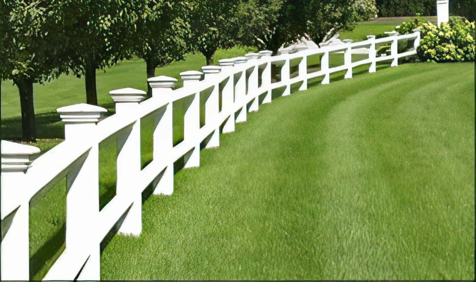 Vinyl 2-rail ranch fence in serene country setting with farmhouse, open field, grassy lawn, and trees in the background.