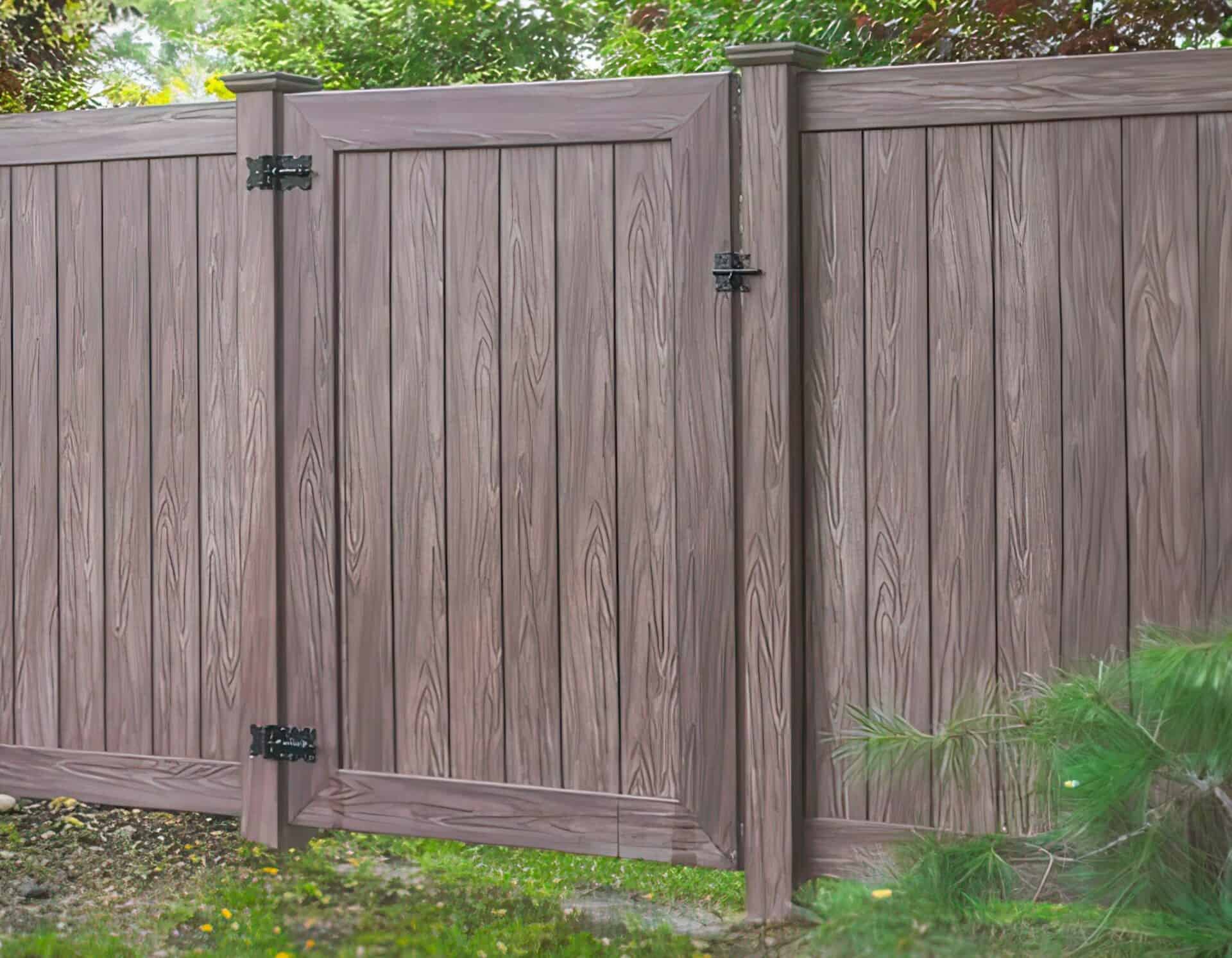 Vinyl doors and fence with trees in the background, creating a natural and durable outdoor aesthetic
