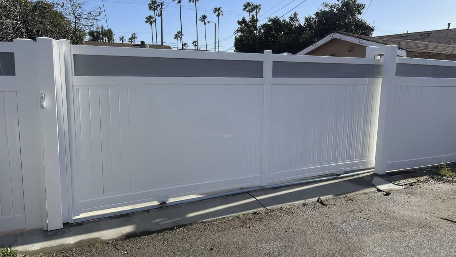 Tall vinyl rolling gate giving access to small suburban house driveway and fron yard from the road with improved security